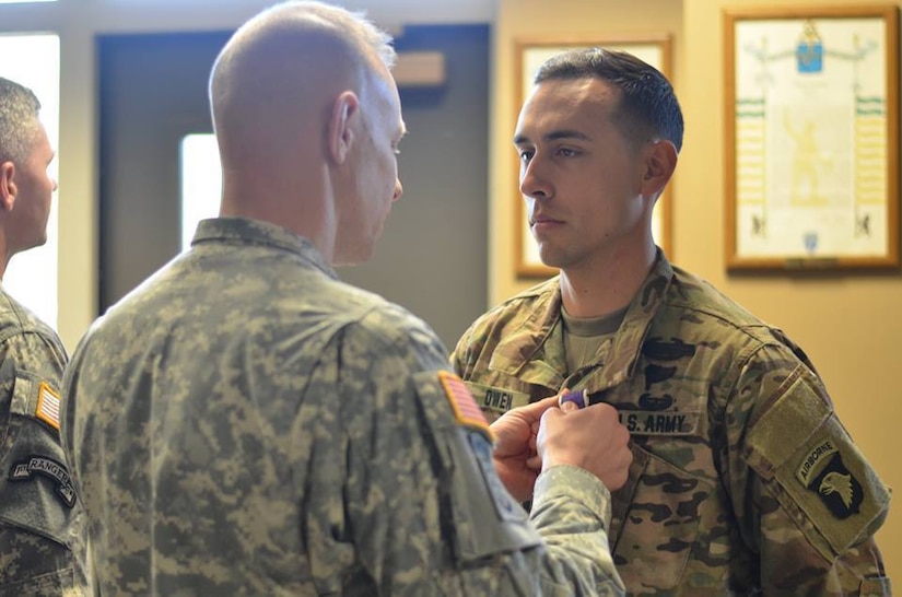 Army Col. Brett G. Sylvia, left, commander of the 2nd Brigade Combat Team, 101st Airborne Division, presents the purple heart medal to Sgt. Addison Owen, 1st Battalion, 26th Infantry Regiment, during a ceremony at Fort Campbell, Ky., Dec. 18, 2015. Owen was wounded while assigned to the 1st Cavalry Division in Iraq during a 2010-2011 rotation. Army photo by Staff Sgt. Sierra Melendez