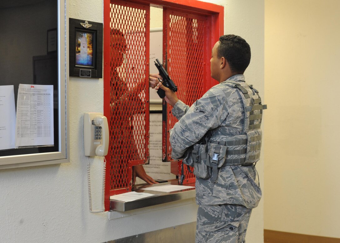 U.S. Air Force Airman Austin Bryant, 7th Security Forces Squadron security forces member, is issued a M9 pistol prior to the start of his shift at the 7th SFS armory at Dyess Air Force Base, Texas, Nov. 17, 2016. Airmen living on base that own firearms must register their weapons with the 7th Security Forces Squadron. Those living in base housing are allowed to keep them in their home, but those in the dorms are required to store their weapons and ammunition in the 7th SFS armory. (U.S. Air Force photo by Airman 1st Class Rebecca Van Syoc)