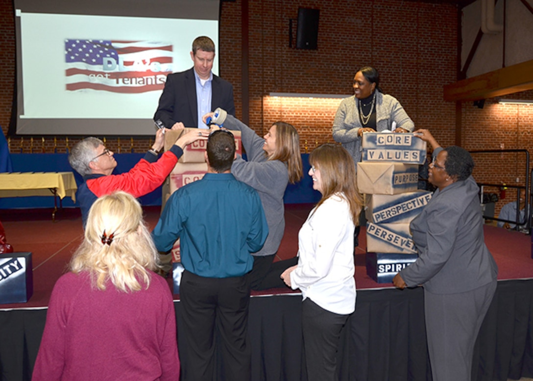 Defense Logistics Agency volunteers from the audience help build the components of the resiliency pillars during an interactive game Nov. 15, 2016, as the activity celebrated Resiliency Day in the Lotts Conference Center on Defense Supply Center Richmond, Virginia. 