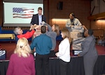 Defense Logistics Agency volunteers from the audience help build the components of the resiliency pillars during an interactive game Nov. 15, 2016, as the activity celebrated Resiliency Day in the Lotts Conference Center on Defense Supply Center Richmond, Virginia. 