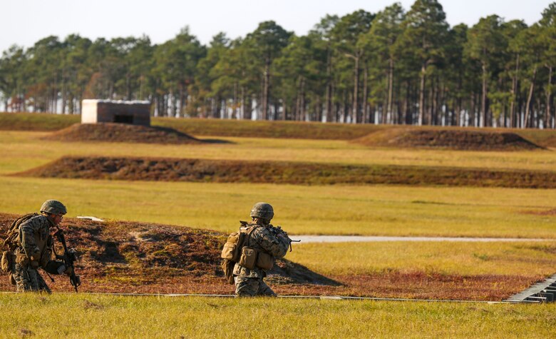 Marines move down into a trench to clear a building during a training exercise at Camp Lejeune, N.C., Nov 16, 2016. The Marines practiced squad-sized movements in order to maintain unit readiness for their upcoming Integrated Training Exercise at the Marine Corps Air Ground Combat Training Center in Twentynine Palms, California. The Marines are with 1st Battalion, 8th Marine Regiment.  (U.S. Marine Corps Photo by Lance Cpl. Jon Sosner)