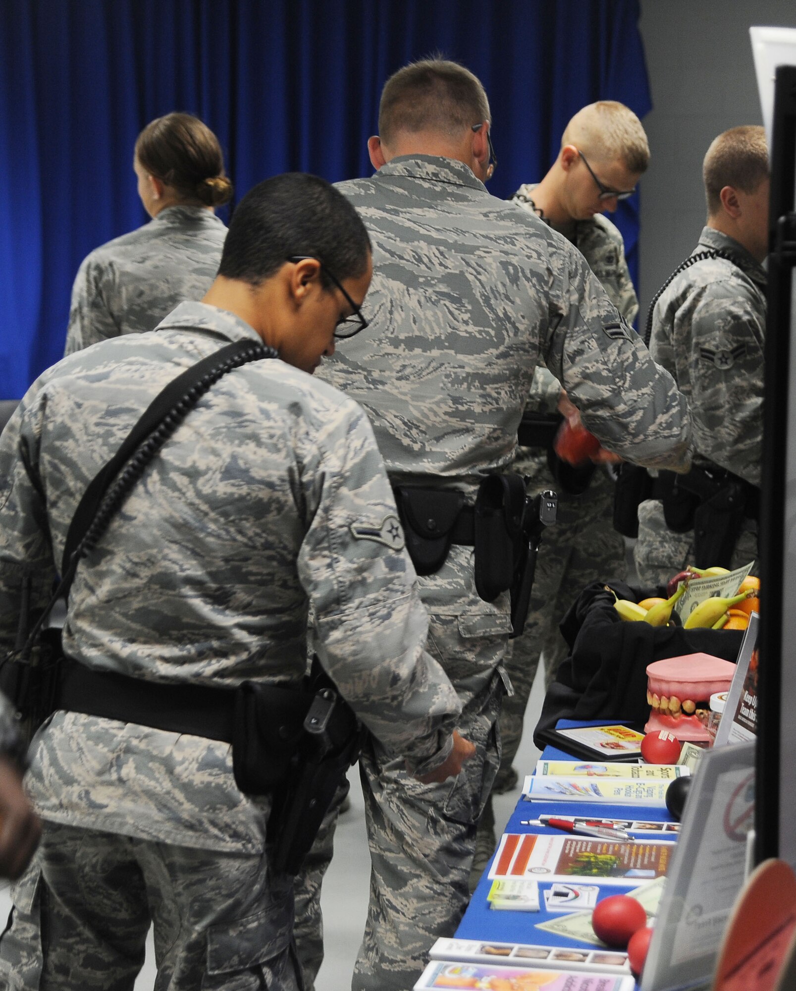 Airmen assigned to the 6th Security Forces Squadron (SFS) browse through information about tobacco health risks and ways to quit during the Great American Smokeout at MacDill Air Force Base, Fla., Nov. 17, 2016. The Health and Wellness Center talked to the 6th SFS before each shift to educate tobacco users about the benefits of quitting. (U.S. Air Force photo by Airman Adam R. Shanks)