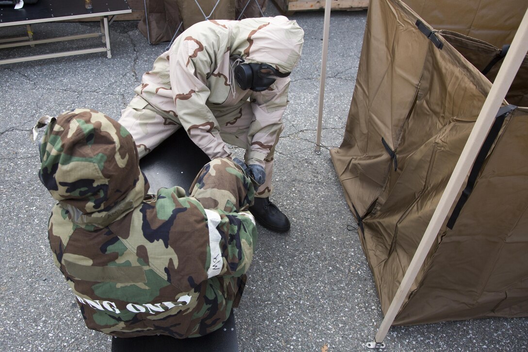Marines and airmen work together at a simulated contamination control area as part of the Vigilant Ace 17-1 exercise at Osan Air Base, South Korea, Nov. 17, 2016. Vigilant Ace is a biannual, bilateral training event where U.S. and South Korean service members conduct interoperability exercises. Marine Corps photo by Lance Cpl. Jacob A. Farbo