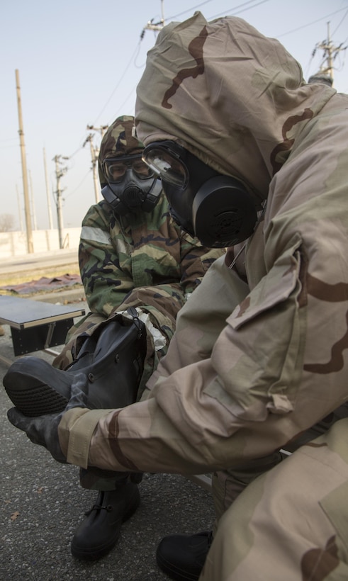 Marines and airmen work together at a simulated contamination control area as part of the Vigilant Ace 17-1 exercise at Osan Air Base, South Korea, Nov. 17, 2016. Vigilant Ace is a biannual, bilateral training event where U.S. and South Korean service members conduct interoperability exercises. Marine Corps photo by Lance Cpl. Jacob A. Farbo