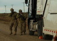 (From left) Senior Airman Dustin Silc and Staff Sgt. Tyler Chronister, 791st Missile Security Forces Squadron convoy response force members, perform a perimeter sweep of a payload transporter during a recapture and recovery exercise at the missile complex, N.D., Nov. 16, 2016. During the simulated scenario, defenders recovered an asset that was taken over by hostile forces. (U.S. Air Force photo/Senior Airman Apryl Hall)