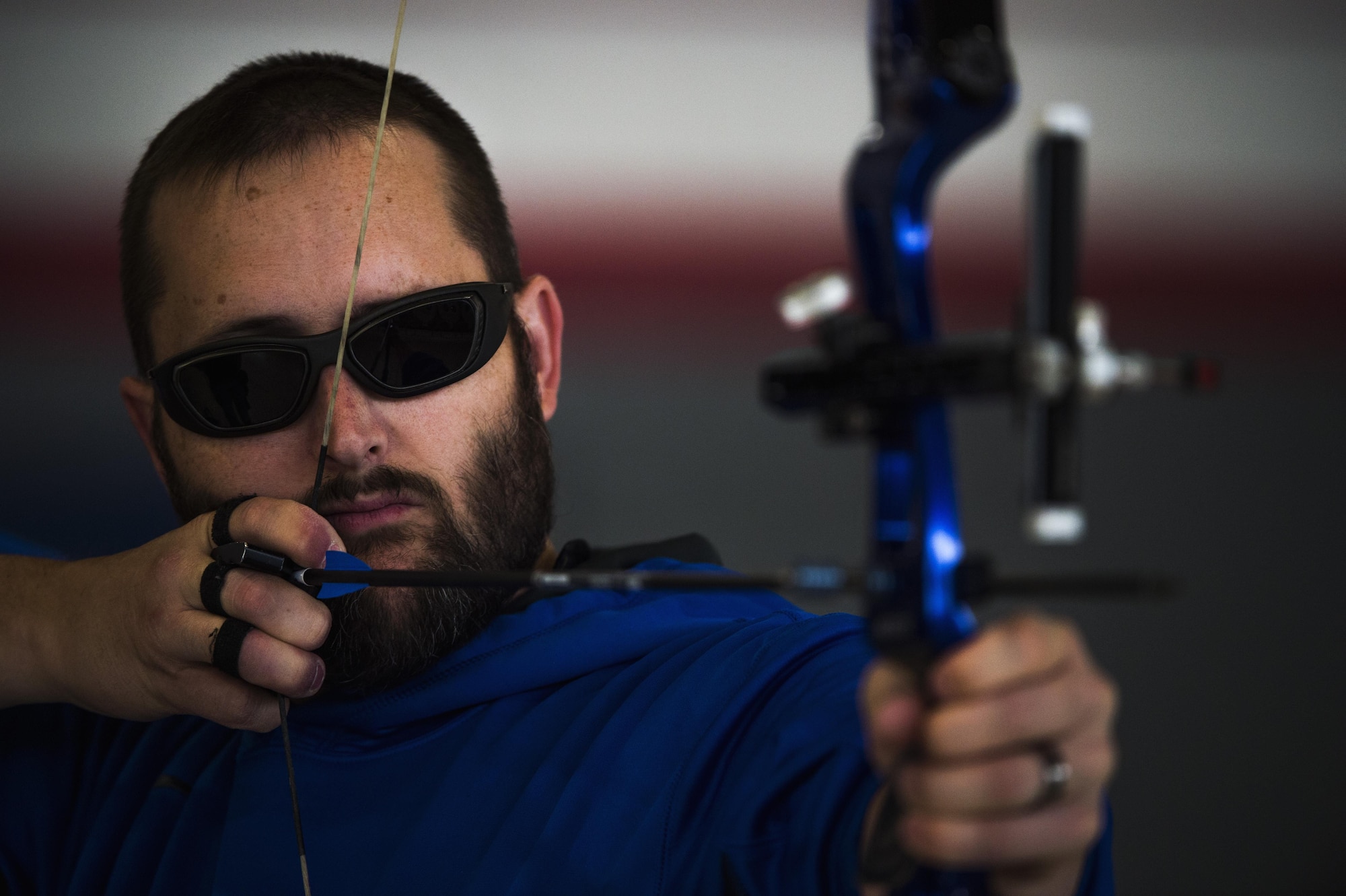 Josh Leary, Retired U.S. Air Force and wounded warrior, pulls back a bow as he prepares to shoot during the Northeast Region Warrior CARE Event at Joint Base Andrews, Md., Nov. 16, 2016. Leary is visually impaired and can only see four feet in front of him after losing most of his vision while serving in Afghanistan. Leary is given direction by a spotter during shooting. The events are a part of a week-long program that features education in Caregiver Support, Adaptive and Rehabilitative Sports, Recovering Airman Mentorship, and Employment and Career Readiness. (U.S. Air Force photo by Senior Airman Philip Bryant) 