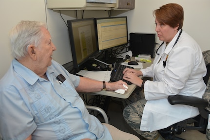 Air Force officer candidate Brandy Williams (right) talks with Jimmie Locke during his appointment in the internal medicine clinic at Brooke Army Medical Center at Joint Base San Antonio-Fort Sam Houston Oct. 19. Williams is a physician assistant student in Phase 2 of the Interservice Physician Assistant Program at BAMC.