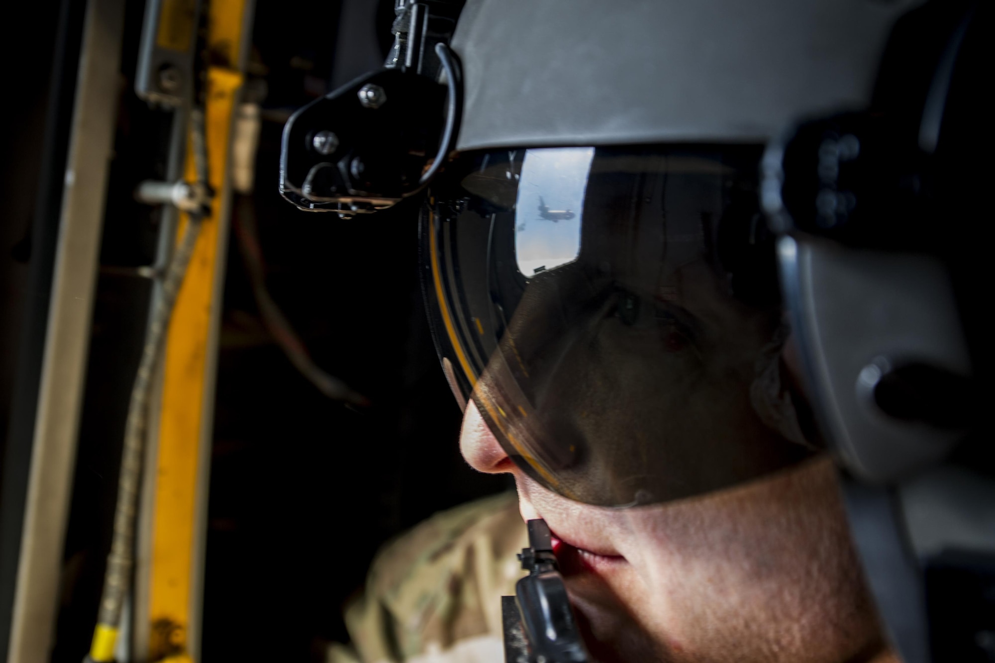 An Air Commando with the 8th Special Operations Squadron observes as a CV-22 Osprey tiltrotor aircraft approaches a KC-10 Extender air-refueling receptacle during a training mission over the Gulf of Mexico, Nov. 18, 2016. The air-refuel mission marked the first time an 8th SOS aircraft has connected to a KC-10. (U.S. Air Force photo by Airman 1st Class Joseph Pick)