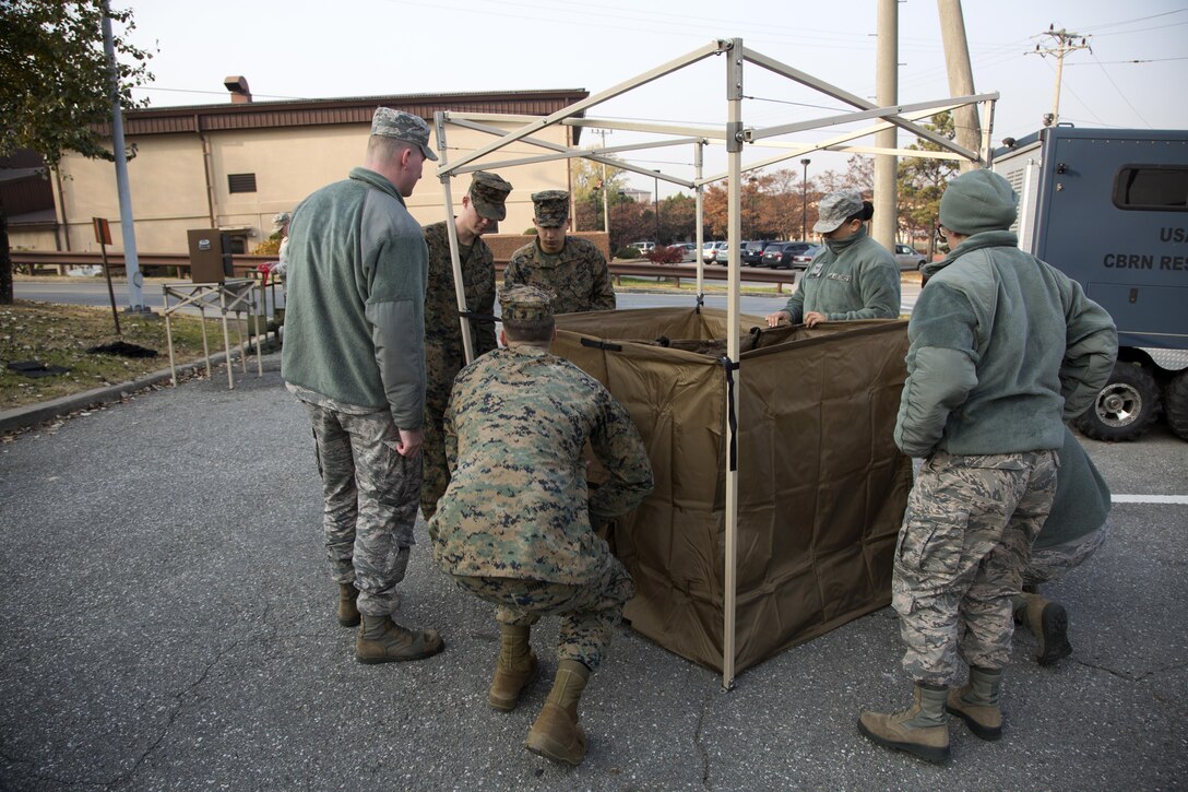 Marines and airmen construct a simulated contamination control area as part of the Vigilant Ace 17-1 exercise at Osan Air Base, South Korea, Nov. 17, 2016. Vigilant Ace is a biannual, bilateral training event where U.S. and South Korean service members conduct interoperability exercises. Marine Corps photo by Lance Cpl. Jacob A. Farbo