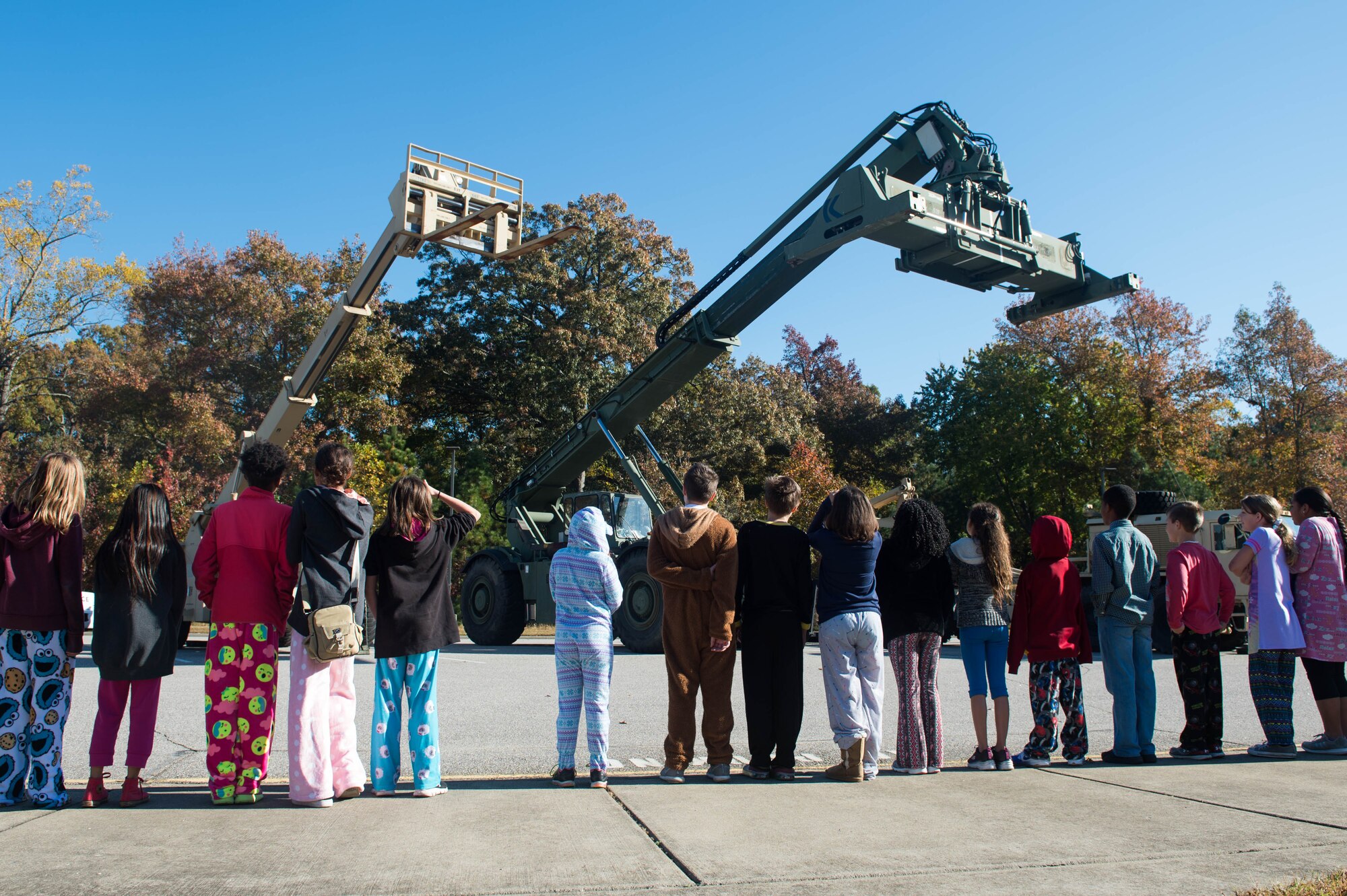 A group of General Stanford Elementary students watch U.S. Army Soldiers operate two forklifts at Joint Base Langley-Eustis, Va., Nov. 18, 2016. The final day of Heroes Week included displays of military vehicles and a military working dog demonstration. (U.S. Air Force photo by Airman 1st Class Derek Seifert)