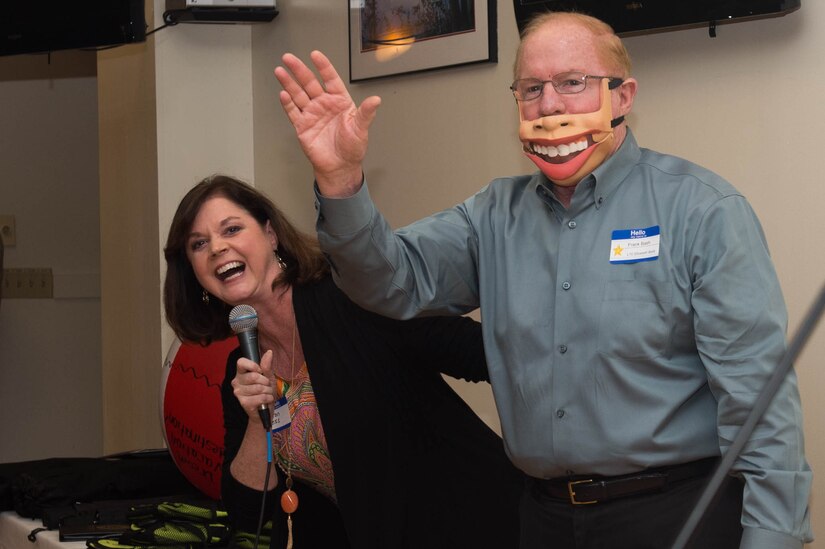 Sharon Dyess, ventriloquist, and her volunteer Frank Bash, Survivor Outreach Services member, perform during the SOS Thanks for Giving Potluck at Joint Base Langley-Eustis, Va., Nov. 17, 2016. The SOS provides support to families, who have lost loved ones, through group meetings and interactions with people experiencing similar situations. (U.S. Air Force photo by Airman 1st Class Derek Seifert)