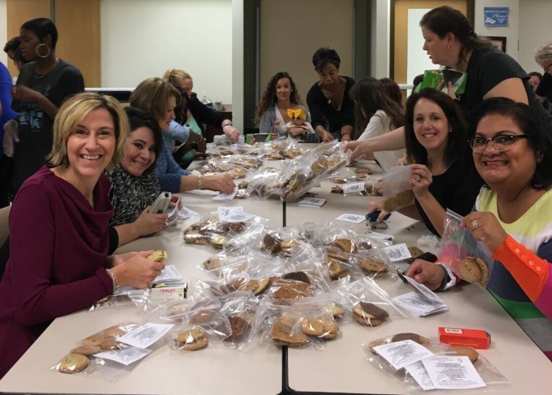 Members of the Women of the Chapel (WOC) Cookie Ministry gathered Nov. 17, before their weekly bible study to bag and tag over 2,500 cookies which will be delivered to the Marines and Sailors living in the barracks. 