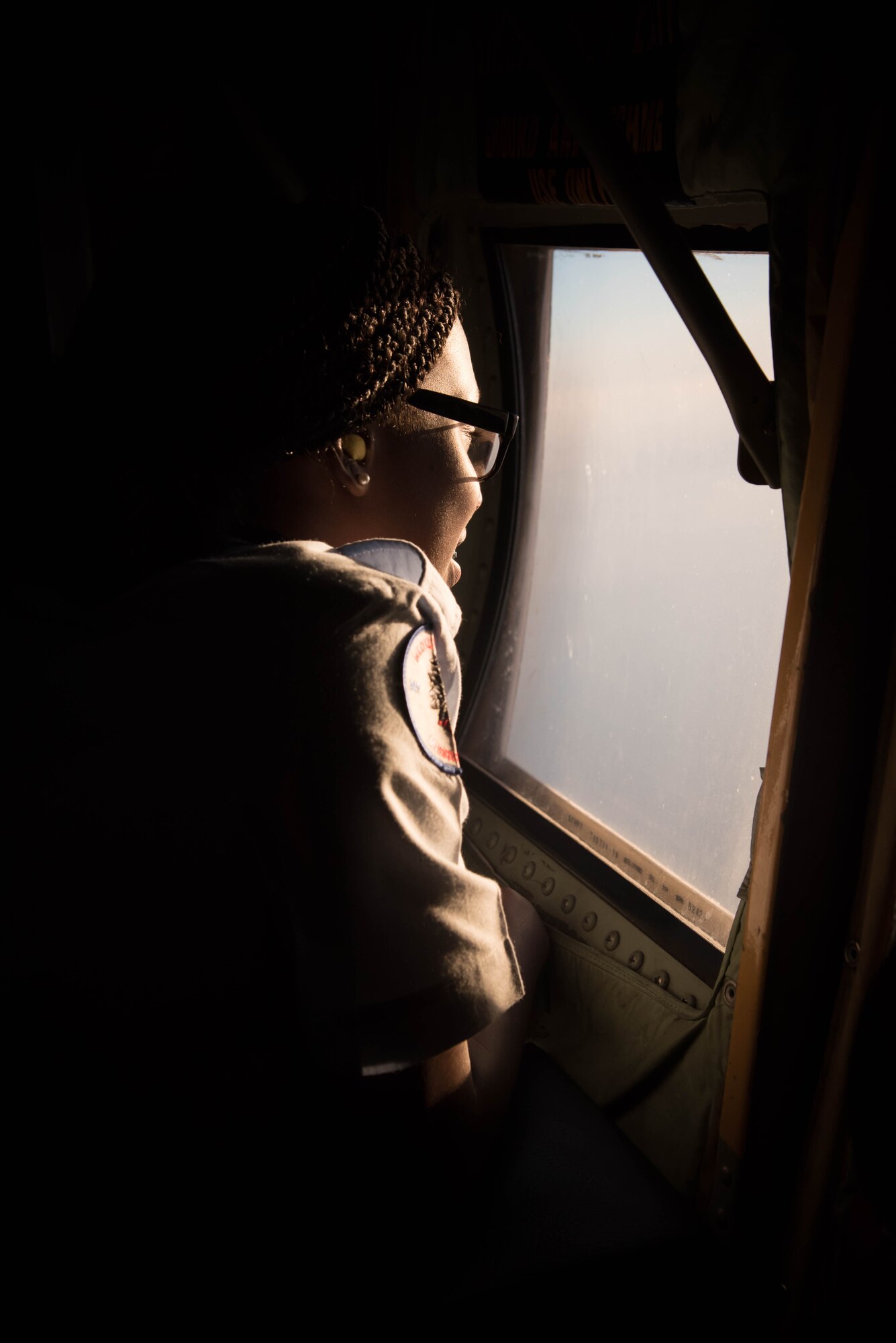 A student from the Biloxi High School JROTC team looks out the window of a WC-130J Super Herculese Aircraft. Her team won the Biloxi High School JROTC team won the Mississippi All Services JRTOC Drill Competition Nov. 18 at Keesler Air Force Base, Miss. and had a chance to fly with the 53rd Weather Reconnaissance Squadron Hurricane Hunters to learn more about the mission of the Air Force Reserve. (U.S. Air Force photo/Staff Sgt. Heather Heiney) 