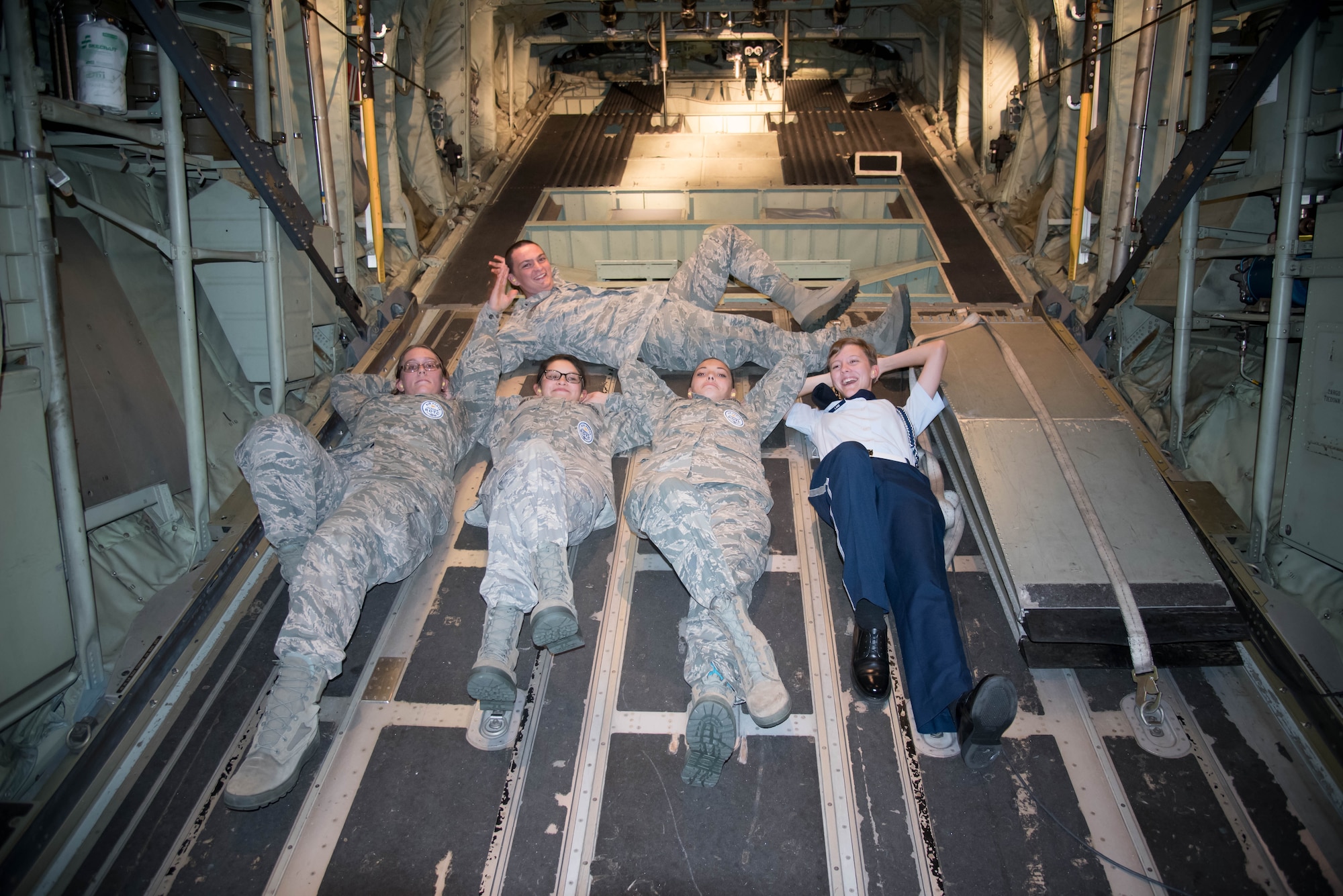 Biloxi High School JROTC students lounge in the back of a WC-130J Super Hercules aircraft. Their team won the Mississippi All Services JRTOC Drill Competition Nov. 18 at Keesler Air Force Base, Miss. and had a chance to fly with the 53rd Weather Reconnaissance Squadron Hurricane Hunters to learn more about the mission of the Air Force Reserve. (U.S. Air Force photo/Staff Sgt. Heather Heiney) 