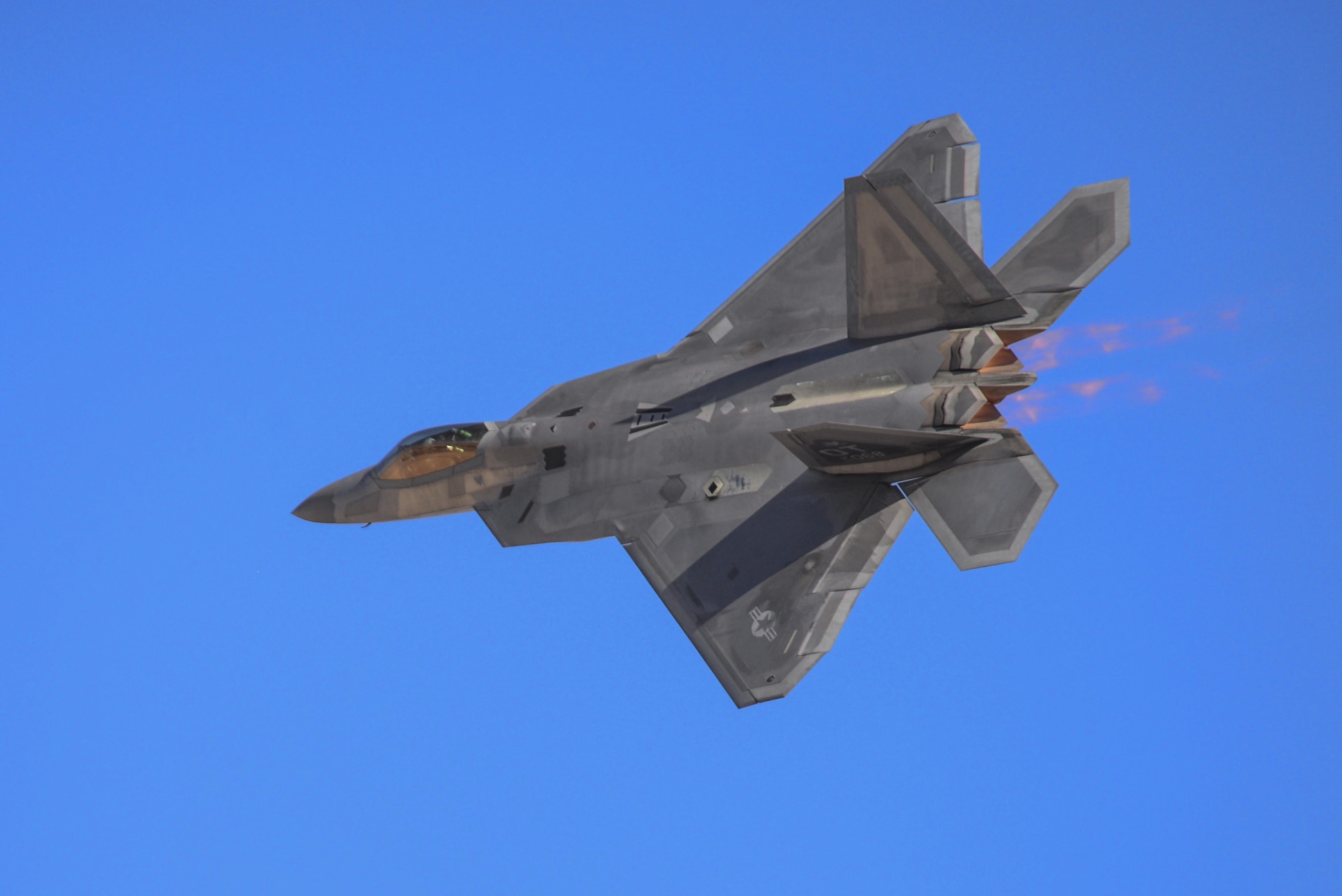 U.S. Air Force Maj. Dan Dickinson, F-22 Raptor Demonstration Team pilot, executes a transition maneuver during the 2016 Air Power over Southern Nevada Air Show at Nellis Air Force Base, Nev., Nov. 13, 2016.  Dickinson is an F-22 fighter pilot with more than 900 flying hours.  (U.S. Air Force photo by 2nd Lt. Mahalia Frost)