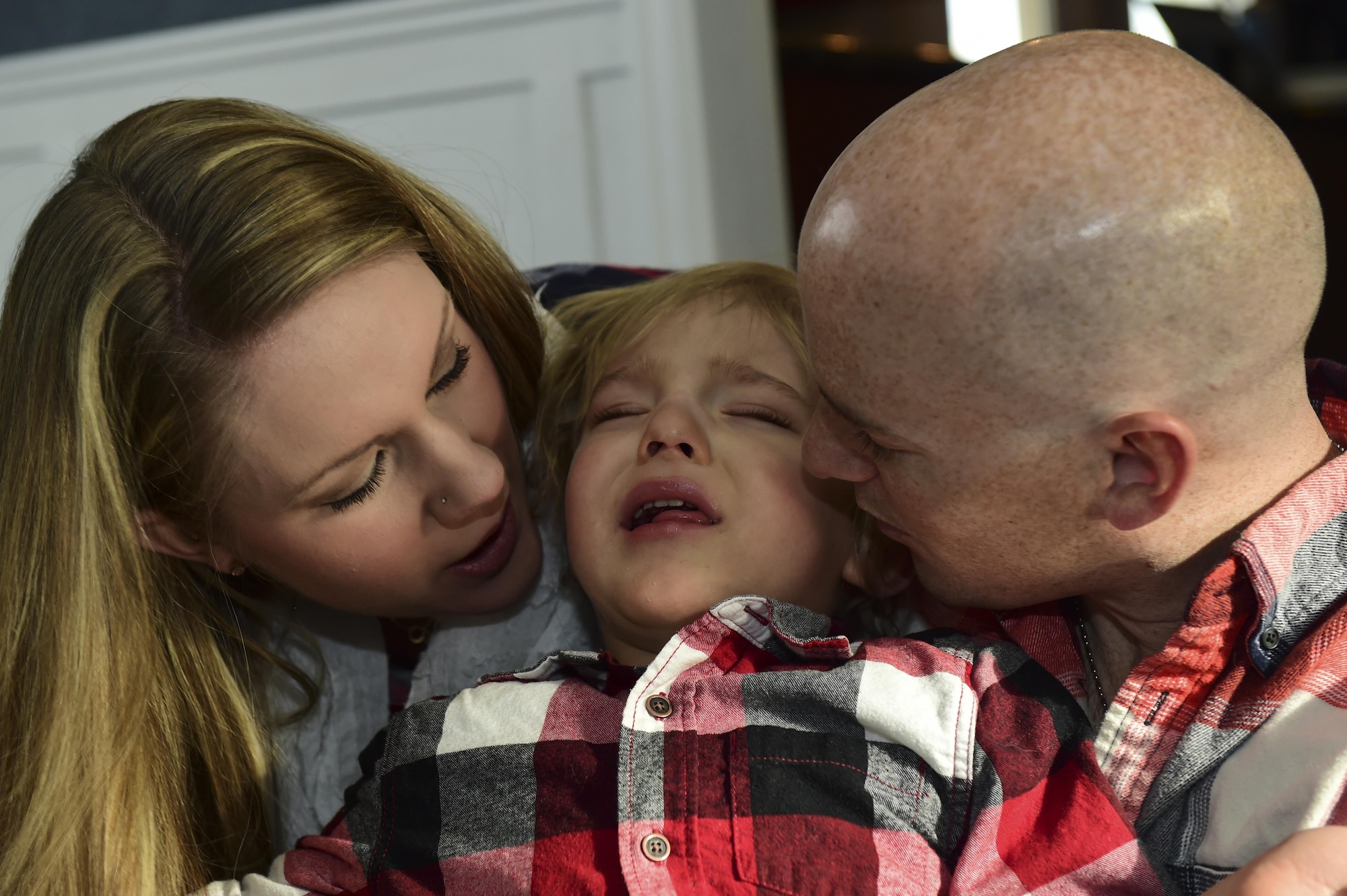 Mandy and Capt. Matthew Douglas, Air Force Space Command logistical and support officer, embrace their child Dean during a birthday celebration, Nov. 2, 2016, in Colorado Springs, Colo. Dean and his brother Luke were born premature at 23 weeks, 17 weeks earlier than normal. (U.S. Air Force photo by Airman 1st Class Gabrielle Spradling/Released)