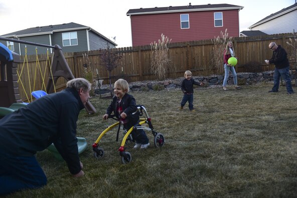 The Douglas family spends an afternoon outside playing Nov. 2, 2016, in the backyard of their family home in Colorado Springs, Colo. The twins enjoy playing outside; however, if they are too active there is a chance of them vomiting due to their vocal chords not functioning properly, stemming from premature birth complications. (U.S. Air Force photo/Airman 1st Class Gabrielle Spradling)