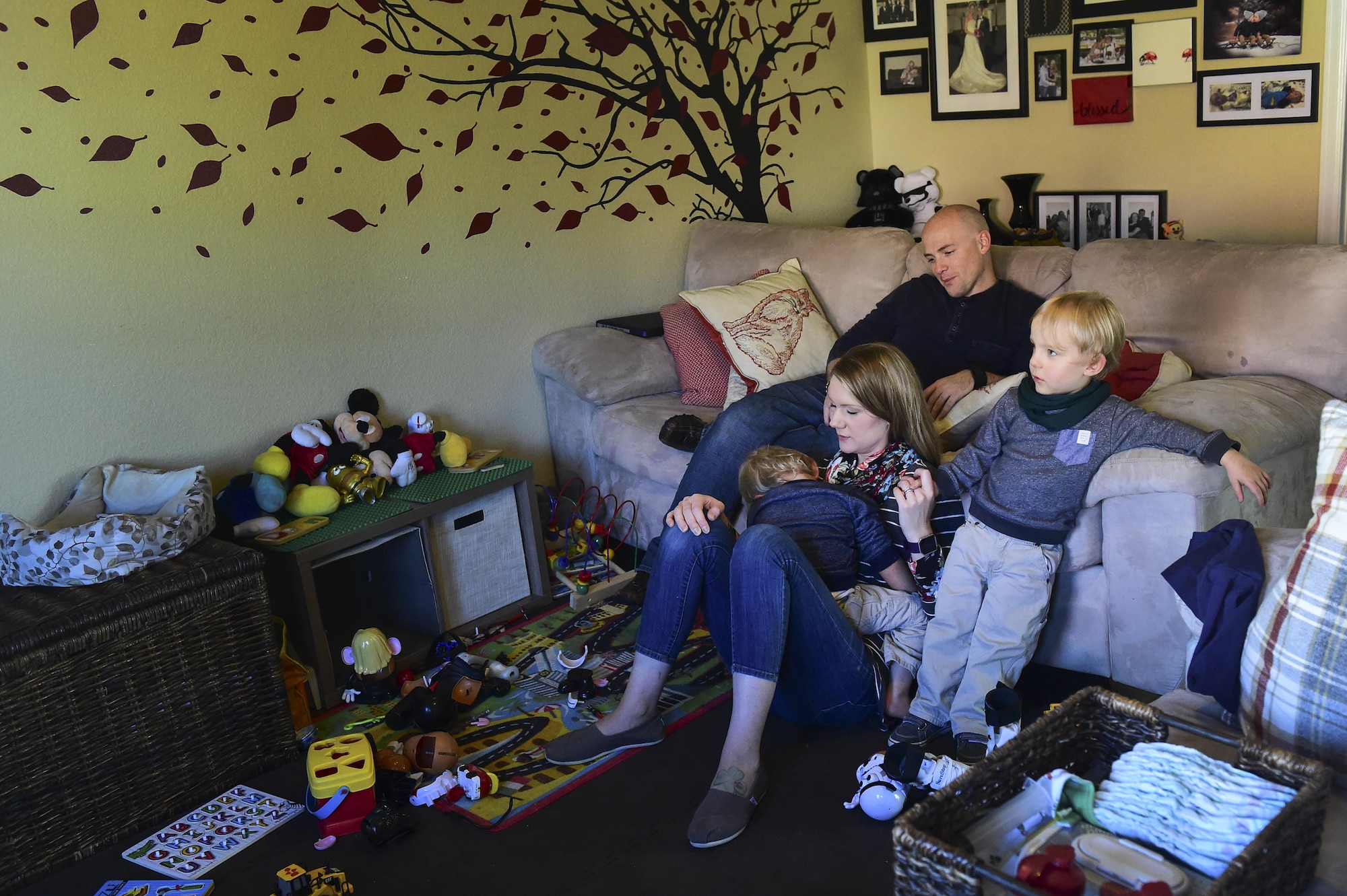 The Douglas family sits together Nov. 3, 2016, at their home in Colorado Springs, Colo. The parents not only tackle everyday tasks, such as keeping a clean house and working, but they also take care of their twin boys who suffer from many medical issues due to a complicated, premature birth. (U.S. Air Force photo by Airman 1st Class Gabrielle Spradling/Released)