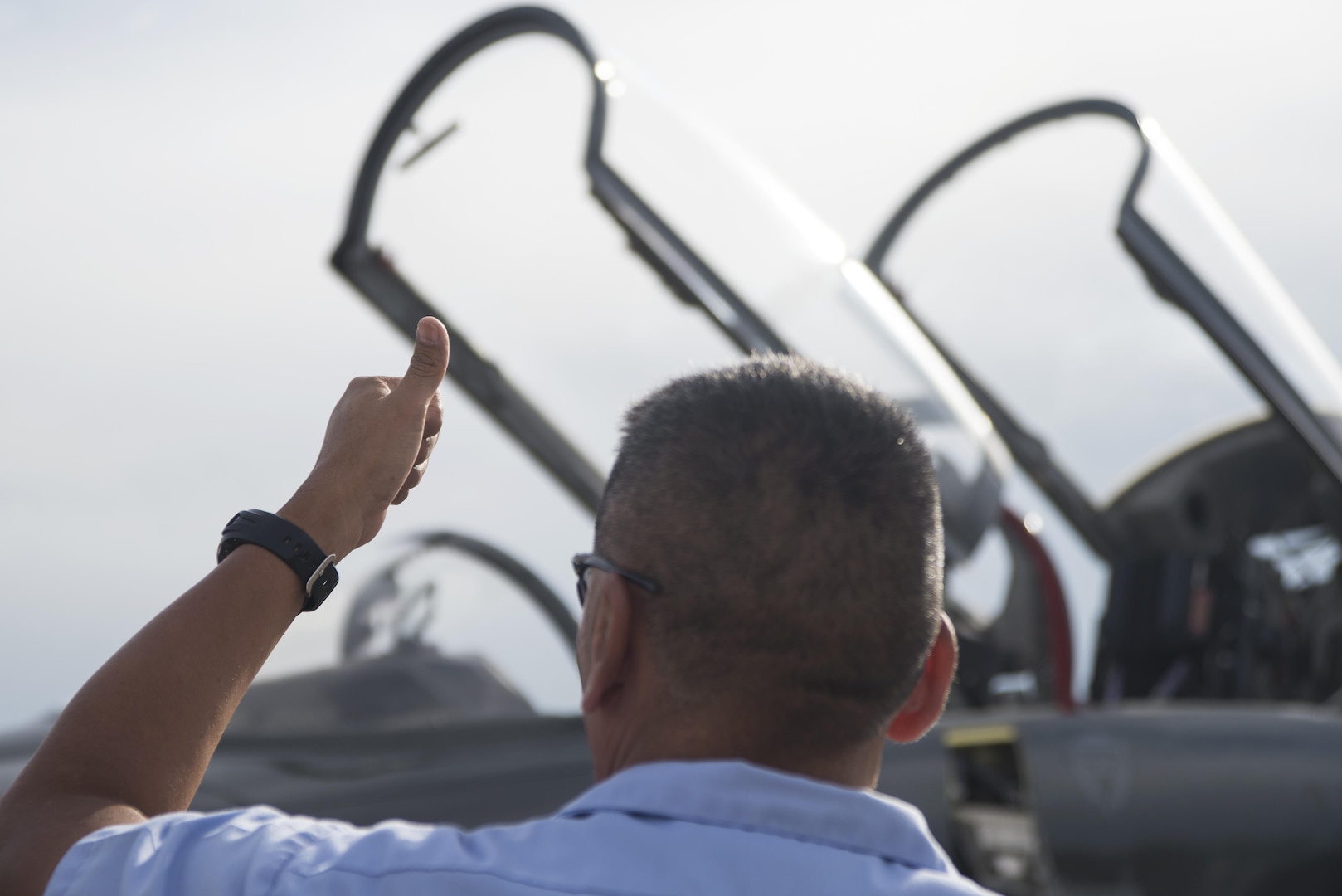 Chris Bahe, 12th Flying Training Wing T-38C Talon II crew chief, hand signals to the pilot and other aircraft workers that the aircraft is safe and ready for flight at Joint Base San Antonio-Randolph Nov. 8, 2016. Bahe, who retired from the Navy, has also worked on A-6 Intruders, P-3 Orions, F-14 Tomcats and F-18 Hornets. (U.S. Air Force photo by Airman 1st Class Lauren Ely/Released)