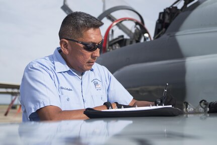 Chris Bahe, 12th Flying Training Wing T-38C Talon II crew chief, signs off on a line-per-line item sheet to finish a pre-flight walk-around inspection at Joint Base San Antonio-Randolph Nov. 8, 2016. Bahe has been a crew chief at JBSA-Randolph since 2007. (U.S. Air Force photo by Airman 1st Class Lauren Ely/Released)
