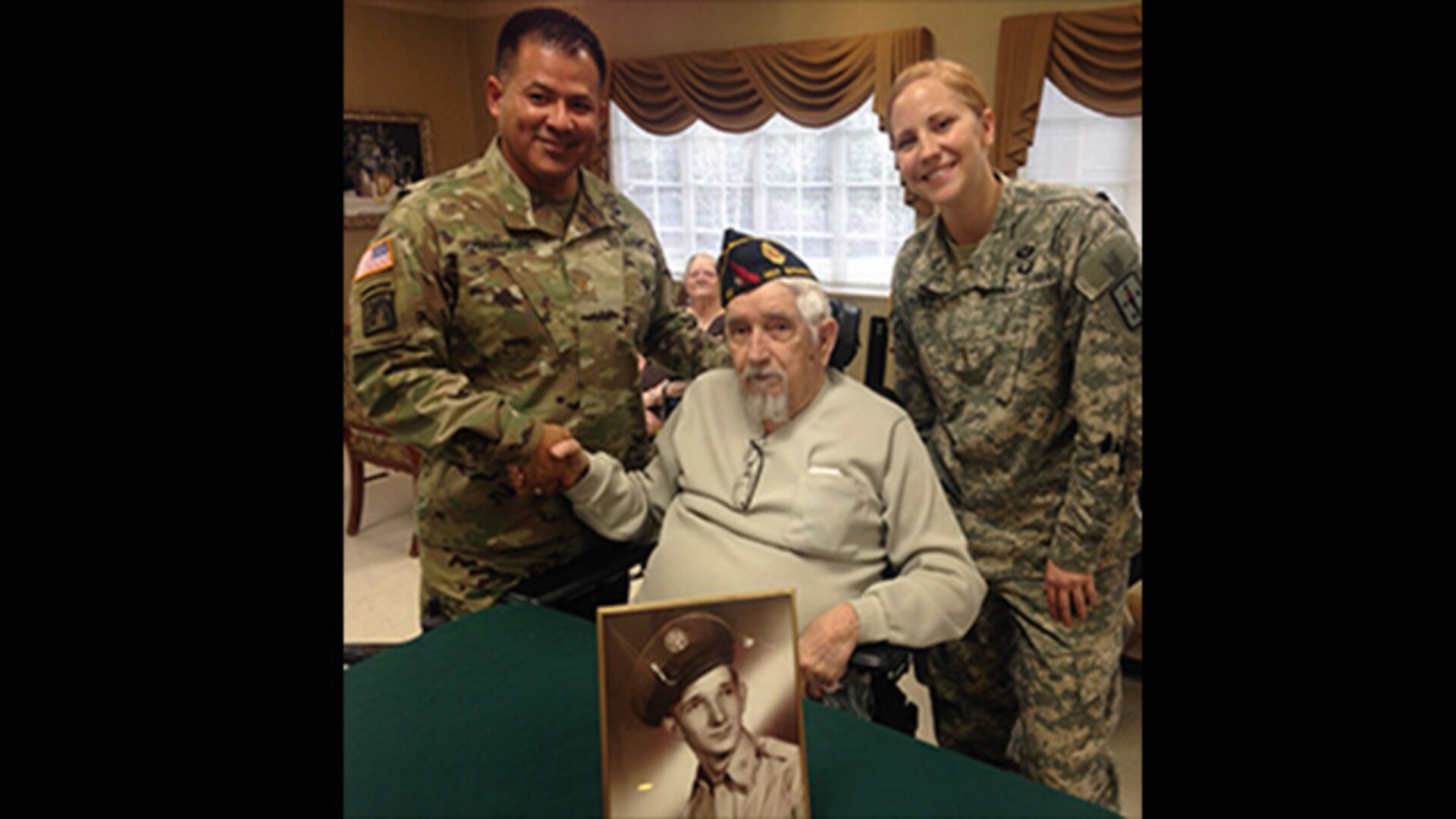 Defense Logistics Agency Aviation’s Army Maj. Alex Shimabukuro (left), operations officer, Customer Facing Division in the Customer Operations Directorate and Army Logistics University’s Basic Officer Leadership Course student, Army 2nd Lt. Nickole Kaple (right) visit veterans at Appomattox Health and Rehab Center in Hopewell, Virginia Nov. 9, 2016 for a Veterans Day celebration. World War II Air Force Veteran Paul Boyett (center) was among those presented with a pin and certificate for his service during a "pinning and certificate" ceremony held at the facility.