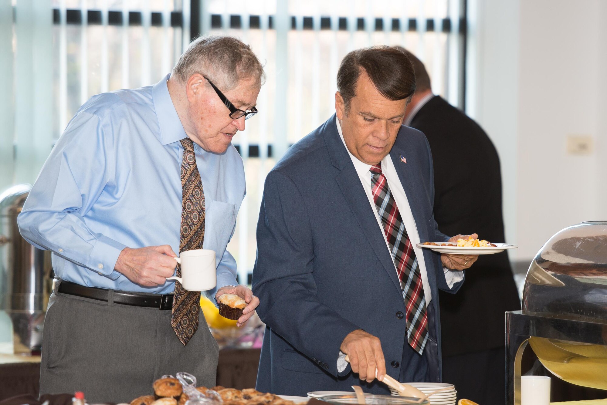 Civic leaders select refreshments at the 2016 Military Construction Breakfast Nov. 21, 2016, at the Landings on Dover Air Force Base, Del. The annual brief updates community leaders on current, ongoing and upcoming base construction projects. (U.S. Air Force photo by Mauricio Campino)