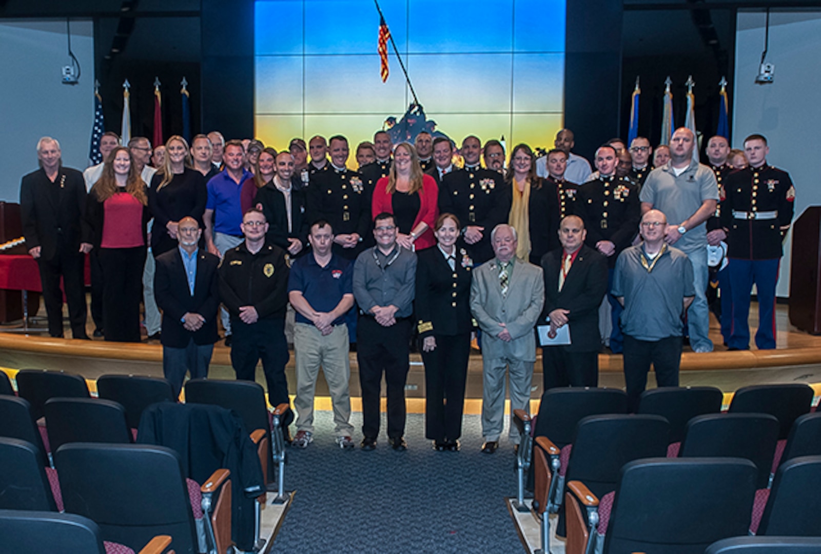 Former and current Marines working on Defense Supply Center Columbus, along with DLA Land and Maritime commander, RDML Michelle Skubic, pose for a group photo at the conclusion of the DSCC Marine Corps Birthday celebration Nov. 9 inside the Land and Maritime Operations Center auditorium.