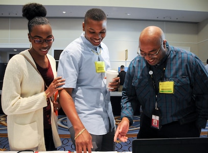 Spc. Roderick Nesbitt, center, and his fiancé Tiana Small, left, speak with Dominique Graham, Army Reserve recovery care coordinator, during the Army Reserve’s Yellow Ribbon event hosted by the 99th Regional Support Command Nov. 18-20 at the Gaylord National Resort and Convention Center at National Harbor, Maryland. The Yellow Ribbon Program is a Department of Defense-wide effort to promote the well-being of reserve-component service members, their families and communities by connecting them with resources throughout the deployment cycle.