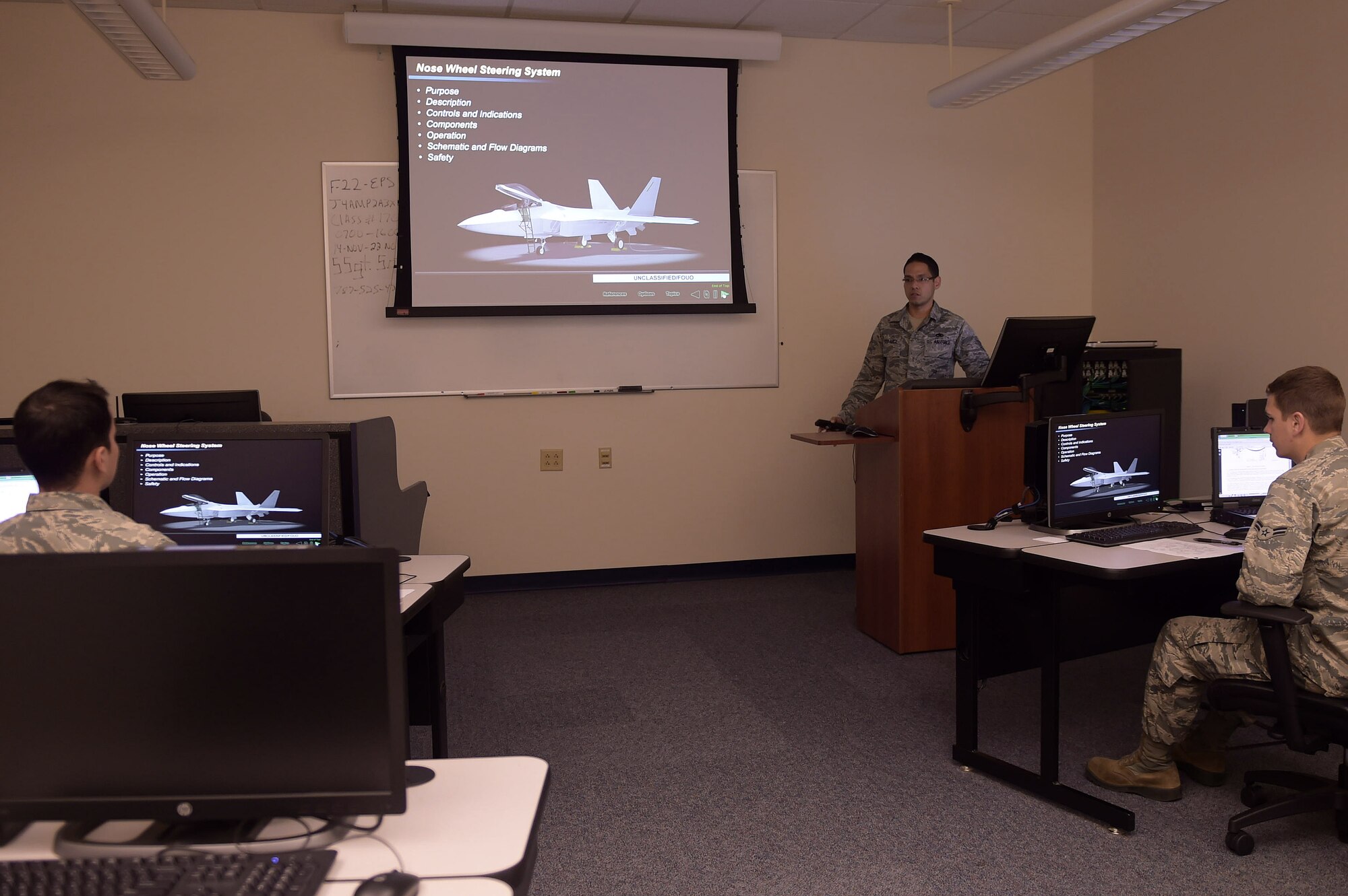 U.S. Air Force Staff Sgt. Guillermo Soto Arce, F-22 Raptor Electrical System Maintenance instructor, teaches students in an advanced training course at Joint Base Langley-Eustis, Va., Nov. 17, 2016. During their time in the course, students will get classroom time with their instructors, going in-depth into the information they will need to repair, examine or report on their aircraft. After the classroom time, they will get hands-on experience with training equipment as well as some active aircraft. (U.S. Air Force photo by Senior Airman Kimberly Nagle)