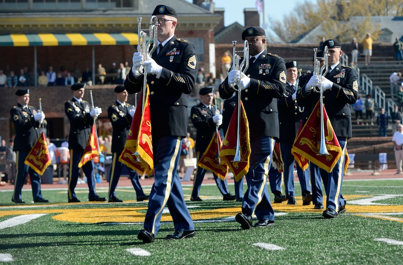 U.S. Army Training and Doctrine Command Band Herald Trumpets march into formation at, the College of William & Mary,military appreciation game at Zable Stadium in Williamsburg, Va., Nov. 19, 2016. The Herald Trumpets perform for more than 30,000 spectators each year at events ranging from military ceremonies to local sports arenas. (U.S. Air Force photo by Airman 1st Class Kaylee Dubois)
