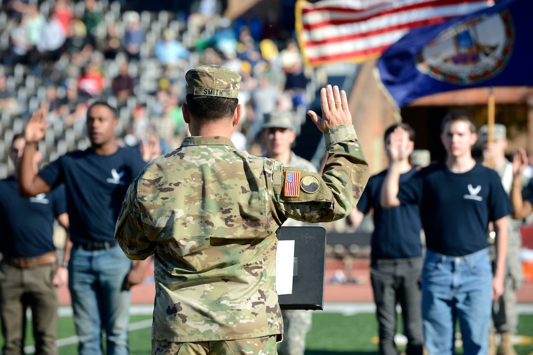 U.S. Army Col. Scott Smith, Virginia National Guard commander, recites the oath of enlistment ceremony for U.S. Air Force and U.S. Army recruits at the College of William & Mary military appreciation game at Zable Stadium in Williamsburg, Va., Nov. 19, 2016. More than 15 recruits, including members of the William & Mary ROTC program, participated in the ceremony. (U.S. Air Force photo by Airman 1st Class Kaylee Dubois)