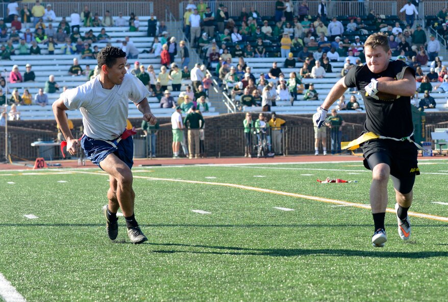 U.S. Air Force Senior Airman Courtland Banks, 1st Aircraft Maintenance Squadron maintenance supply technician, chases a member of the U.S. Army flag football team during the College of William & Mary military appreciation game at Zable Stadium in Williamsburg, Va., Nov. 19, 2016. This was the first year the U.S. Air Force was invited to the William & Mary military appreciation football game. (U.S. Air Force photo by Airman 1st Class Kaylee Dubois)