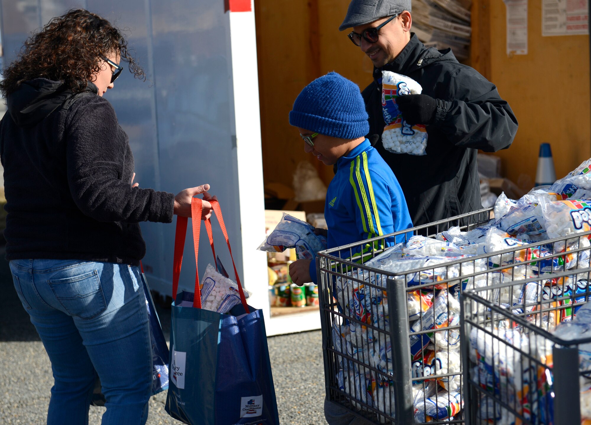 Volunteers with Operation Warmheart fill Thanksgiving bags with food at Joint Base Langley-Eustis, Va., Nov. 20, 2016. The Thanksgiving bags were filled with foods such as canned green beans, yams, boxed potatoes and stuffing. (U.S. Air Force photo by Airman 1st Class Kaylee Dubois)