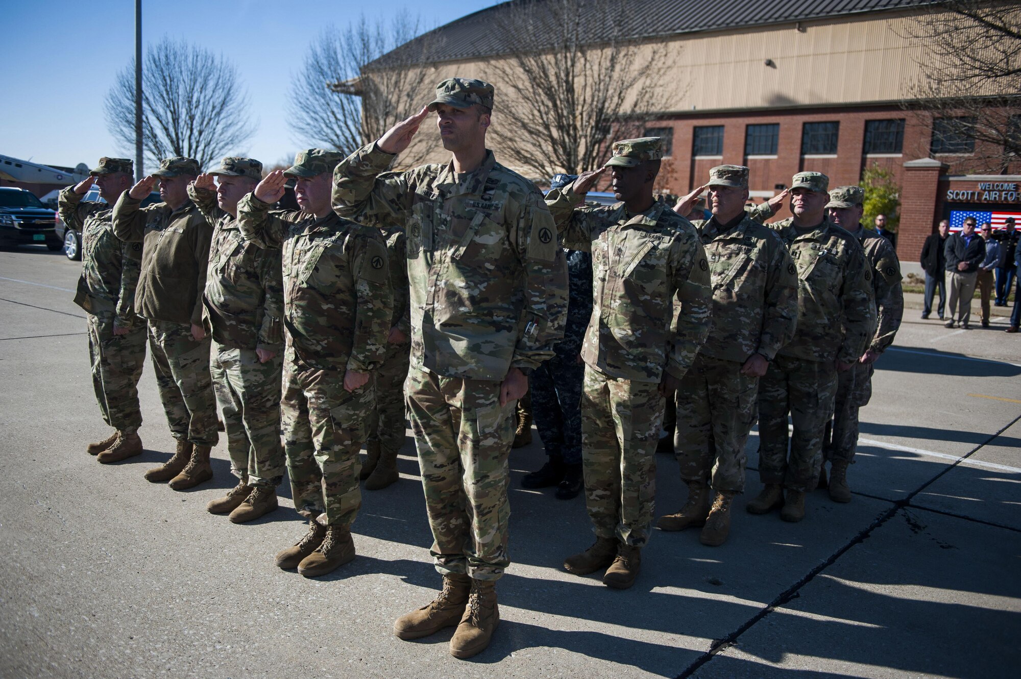Soldiers stationed at Scott Air Force Base, Illinois salute during a dignified transfer ceremony for Pfc. Tyler Iubelt 21 Nov., 2016, at Scott Air Force Base, Illinois. Iubelt passed away on 12 Nov. while deployed to Bagram, Afghanistan. (U.S. Air Force photo by Staff Sgt. Clayton Lenhardt)