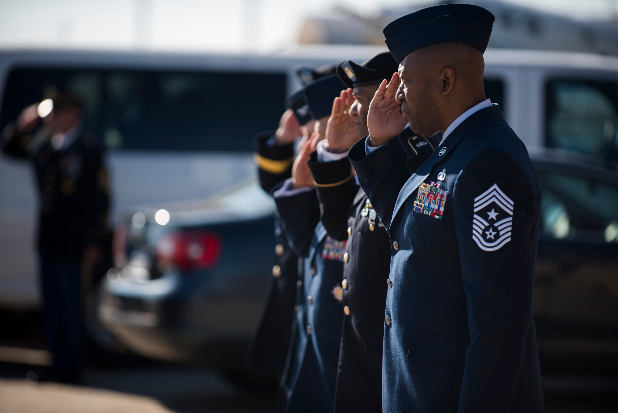 Chief Master Sgt. Wesley Matthias, 375th Air Mobility Wing command chief, salutes during a dignified transfer ceremony for Pfc. Tyler Iubelt 21 Nov., 2016. Iubelt passed away on 12 Nov. while deployed to Bagram, Afghanistan. (U.S. Air Force photo by Staff Sgt. Clayton Lenhardt)