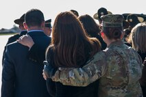 A soldier comforts one of the family members of Private 1st Class Tyler R. Iubelt as his coffin is placed in a hearse at Scott Air Force Base, Ill., Nov. 21, 2016. Iubelt died Nov. 12, 2016, as a result of injuries sustained from an improvised explosive device in Bagram, Afghanistan. He was assigned to Headquarters and Headquarters Company, 1st Special Troops Battalion, 1st Sustainment Brigade, 1st Calvary Division, Fort Hood, Texas, and his hometown is Tamaroa, Illinois. (U.S. Air Force Photo by Senior Airman Megan Friedl)