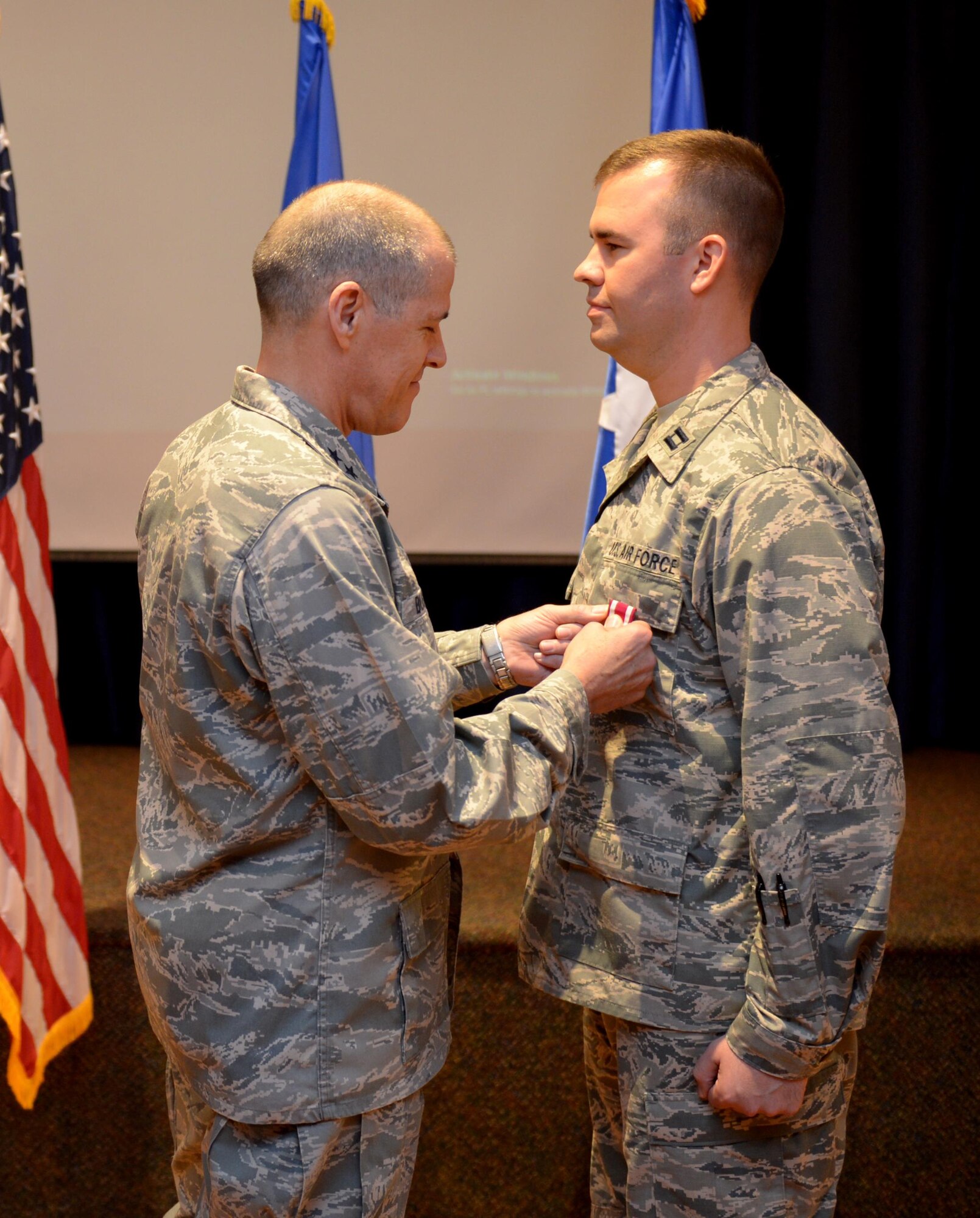 U.S. Air Force Maj. Gen. Thomas Bussiere, 8th Air Force commander, presents the Meritorious Service Medal to Capt. Jason Bland at Barksdale Air Force Base, La., Nov. 17, 2016. (U.S. Air Force photo/Senior Airman Curtis Beach)