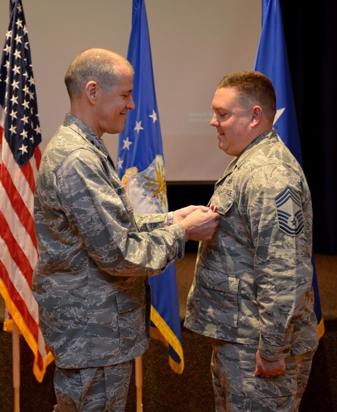 U.S. Air Force Maj. Gen. Thomas Bussiere, 8th Air Force commander, presents the Meritorious Service Medal to CMSgt. Mark Brown at Barksdale Air Force Base, La., Nov. 17, 2016. (U.S. Air Force photo/Senior Airman Curtis Beach)