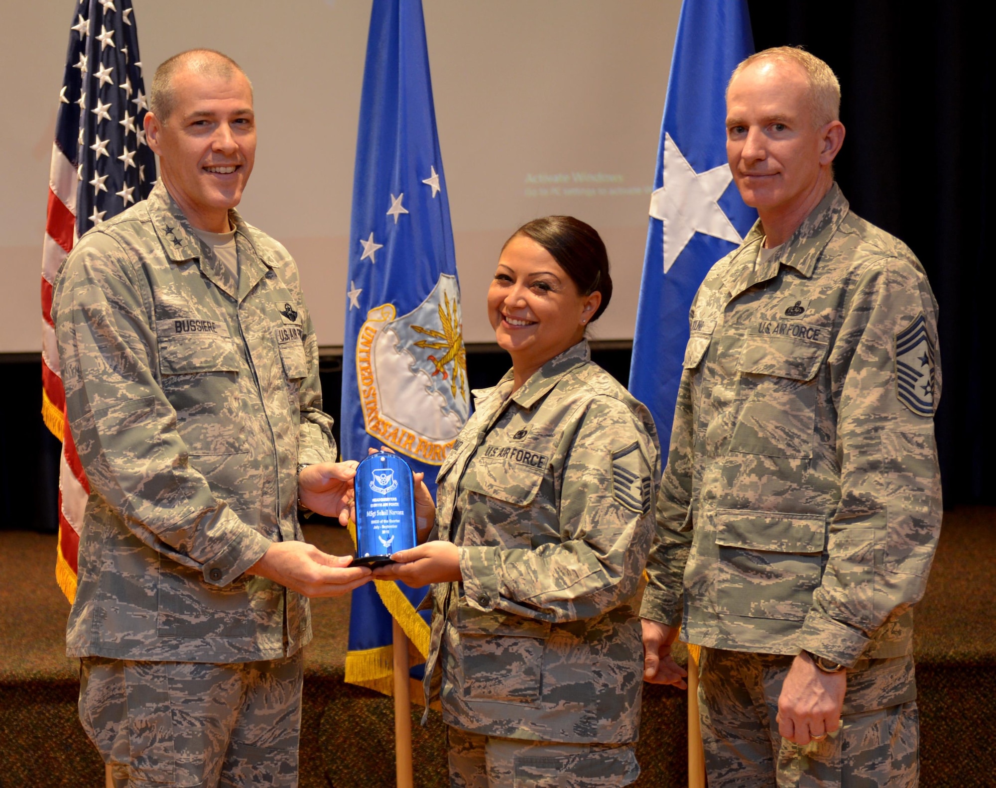 U.S. Air Force Maj. Gen. Thomas Bussiere, 8th Air Force commander, along with CMSgt. Alan Boling, 8th Air Force command chief, recognizes Quarterly Award winner Master Sgt. Suhail Narvaez at Barksdale Air Force Base, La., Nov. 17, 2016. (U.S. Air Force photo/Senior Airman Curtis Beach)