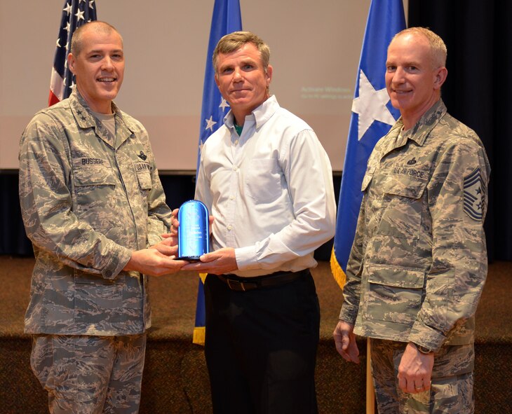 U.S. Air Force Maj. Gen. Thomas Bussiere, 8th Air Force commander, along with CMSgt. Alan Boling, 8th Air Force command chief, recognizes Quarterly Award winner Mr. Douglas Skelton at Barksdale Air Force Base, La., Nov. 17, 2016. (U.S. Air Force photo/Senior Airman Curtis Beach)