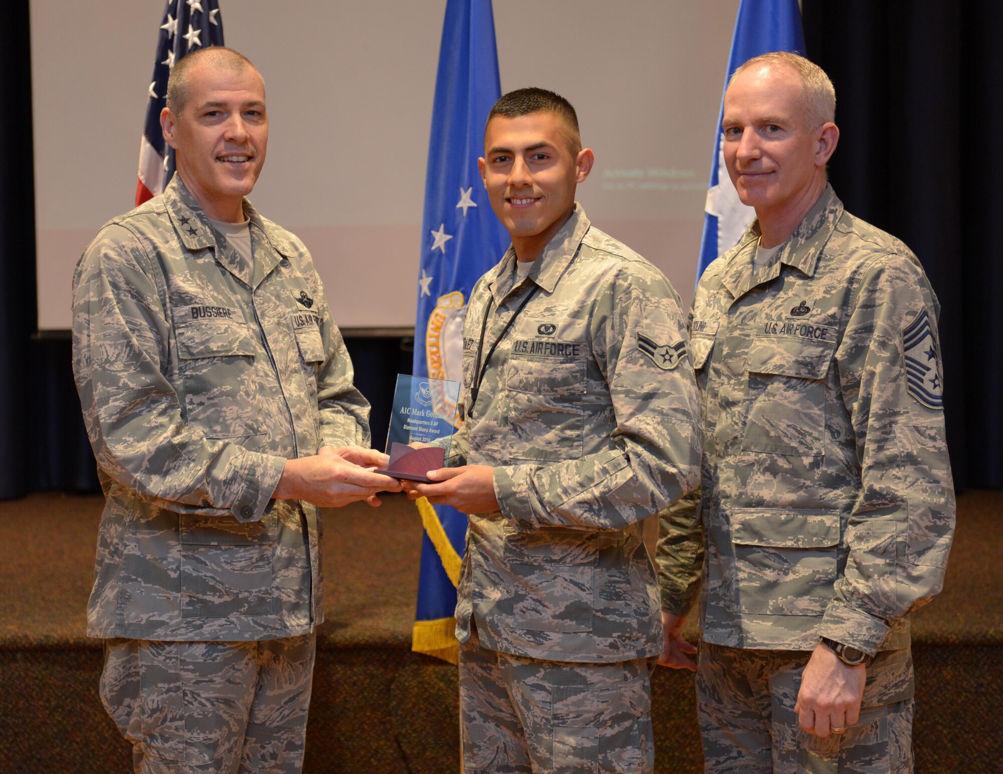 U.S. Air Force Maj. Gen. Thomas Bussiere, 8th Air Force commander, along with CMSgt. Alan Boling, 8th Air Force command chief, recognizes Diamond Sharp Award winner Airman 1st Class Mark Gonzalez at Barksdale Air Force Base, La., Nov. 17, 2016. (U.S. Air Force photo/Senior Airman Curtis Beach)