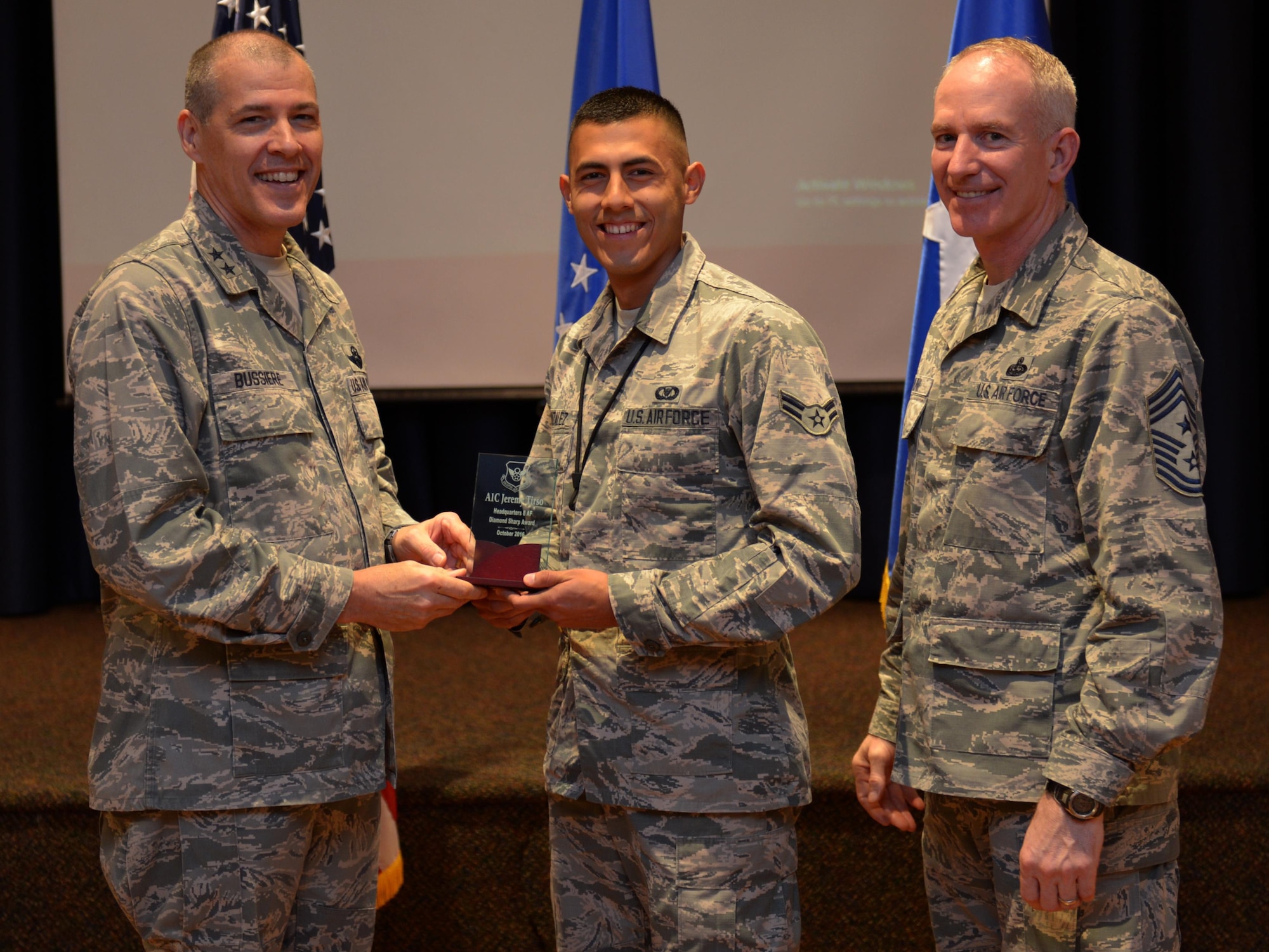 U.S. Air Force Maj. Gen. Thomas Bussiere, 8th Air Force commander, along with CMSgt. Alan Boling, 8th Air Force command chief, recognizes Diamond Sharp Award winner Airman 1st Class Jeremy Tirso at Barksdale Air Force Base, La., Nov. 17, 2016. Accepting on his behalf is Airman 1st Class Mark Gonzalez. (U.S. Air Force photo/Senior Airman Curtis Beach)