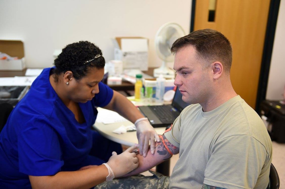 Spc. Christopher Merrell, 85th Support Command, receives an influenza immunization during the command's battle assembly weekend training, Nov 6, 2016. 
(Photo by Sgt. Aaron Berogan)