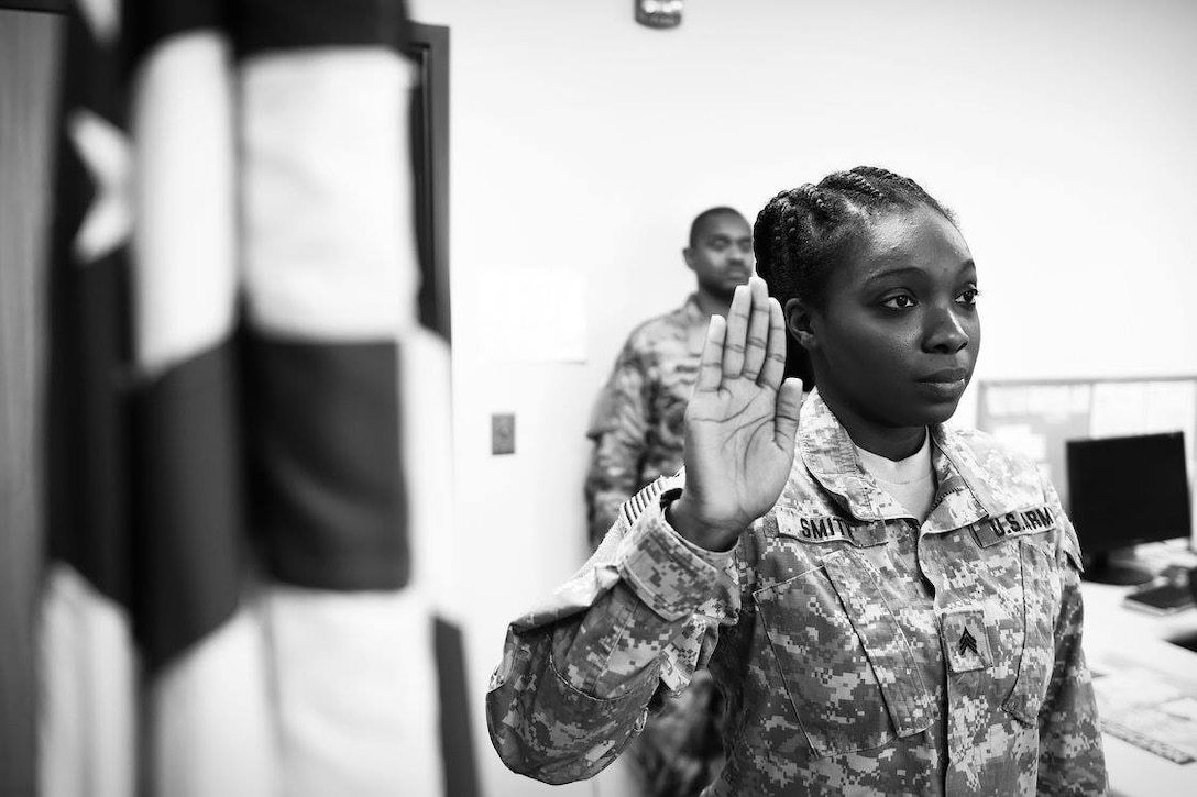 Sgt. Ronyelle Smith, assigned to the 85th Support Command's G4 logistics shop, reenlists during the command's battle assembly weekend, Nov. 6, 2016.
(Photo by Sgt. Aaron Berogan)