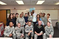 Army Reserve Chief Warrant Officer 3 Monique Perkins, center, 85th Support Command, pauses for a photo with Soldiers and Civilians assigned to the command headquarters, during a baby shower luncheon, Nov. 9, 2016.
(Photo by Anthony L Taylor)