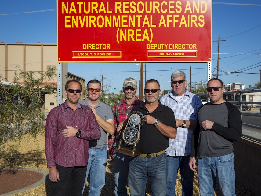 The top riders with Natural Resources and Environmental Affairs stand with a trophy for “Get on Your Bike and Ride” month aboard Marine Corps Air Ground Combat Center, Twentynine Palms, Calif., Nov. 17, 2016. NREA took first place aboard the installation for total miles logged during the 29-day event. (Official Marine Corps photo by Cpl. Levi Schultz/Released)