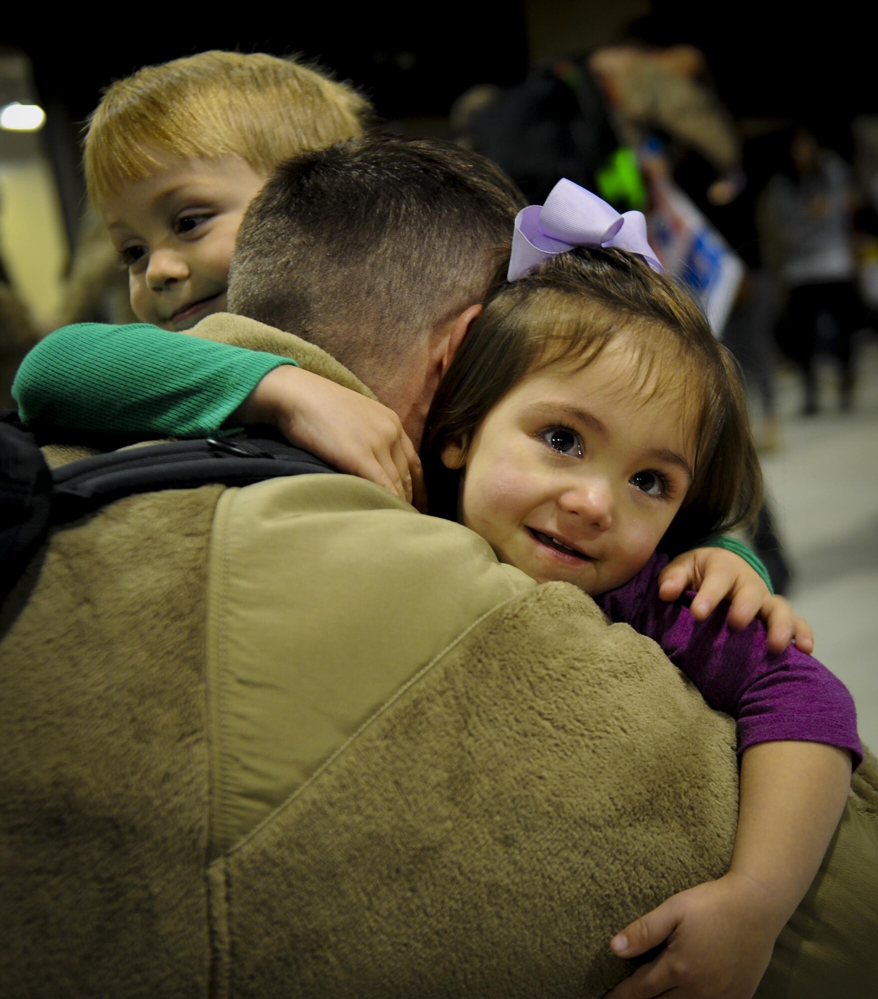 Staff Sgt. Brandon Smith, a geospatial intelligence analyst with the 11th Special Operations Intelligence Squadron, is embraced by his children, upon returning from deployment during Operation Homecoming at Hurlburt Field, Fla., Nov. 10, 2016. Smith, along with 107 other Air Commandos, returned from a four-month deployment. (U.S. Air Force photo by Airman Dennis Spain)