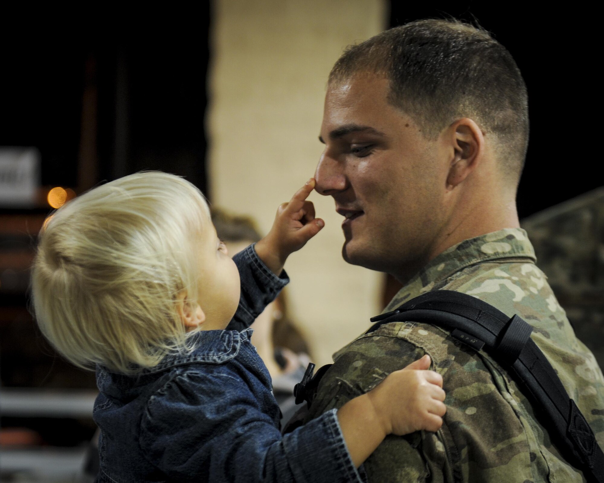 Senior Airman Ryan Randolph, a hydraulic specialist with the 1st Special Operations Maintenance Squadron, holds his child during Operation Homecoming at Hurlburt Field, Fla., Nov. 10, 2016. Randolph, along with 107 other Air Commandos, returned from a four-month deployment. (U.S. Air Force photo by Airman Dennis Spain)