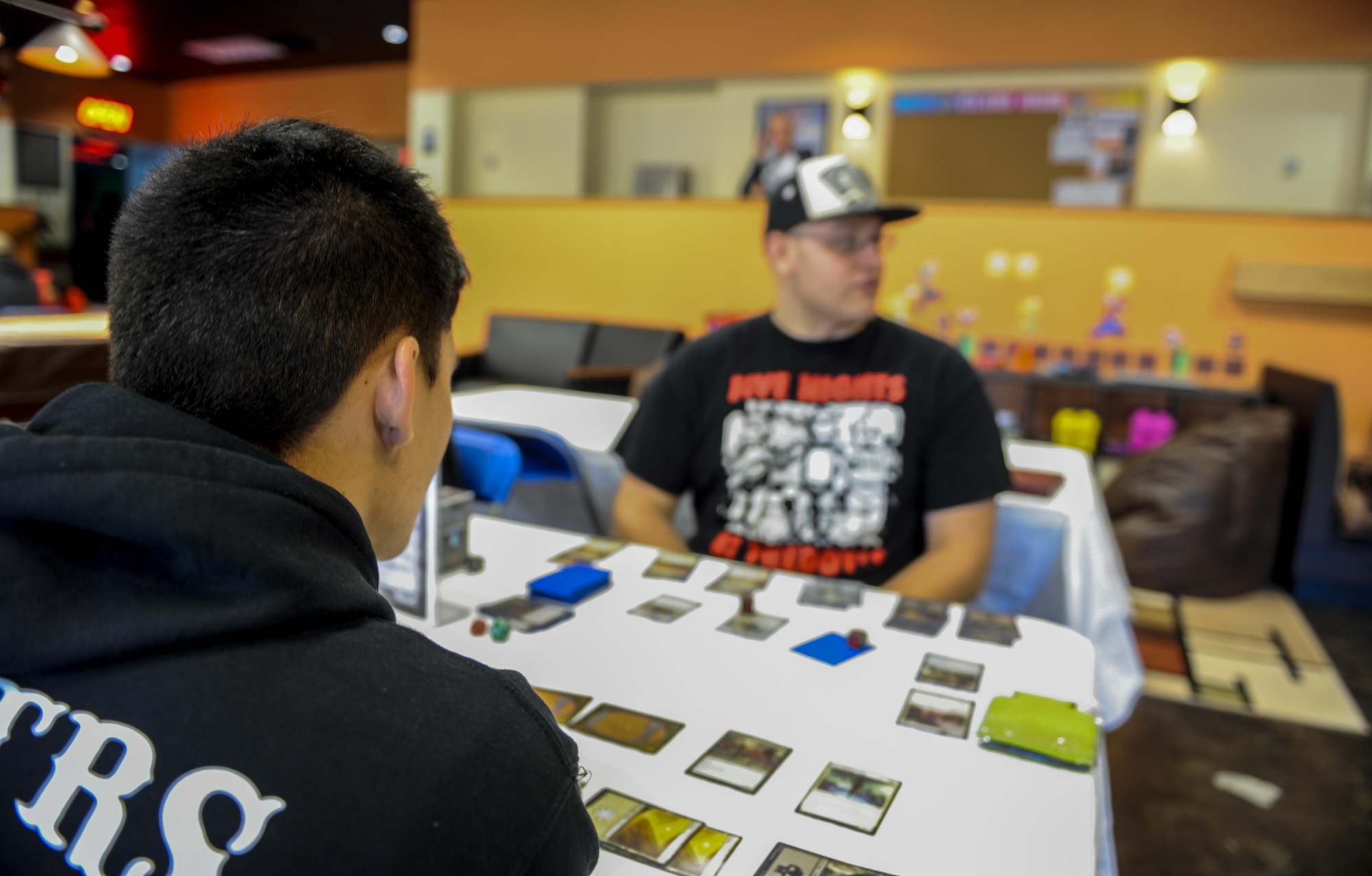 Airman 1st Class Nathan Harris, a personnel specialist with the 1st Special Operations Force Support Squadron, and Airman 1st Class William Cornwell, an aircraft metals technician with the 1st Special Operations Maintenance Squadron, participate in a trading card tournament at the Commando Con event held at the Landing Zone Community Center on Hurlburt Field, Fla., Nov. 19, 2016. Commando Con is based off comic conventions where like-minded individuals immerse themselves in a fantasy world by dressing up as their favorite fictional characters. (U.S. Air Force photo by Airman 1st Class Isaac O. Guest IV)