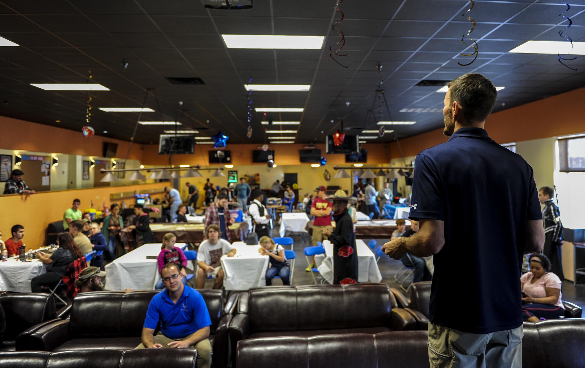 Robert Scott, the 1st Special Operations Force Support Squadron Landing Zone Community Center director, calls out ticket numbers during a raffle drawing at the Commando Con event on Hurlburt Field, Fla., Nov. 19, 2016. Airmen received raffle tickets upon entrance to Commando Con for a chance to win a gaming system and 32’ TV. (U.S. Air Force photo by Airman 1st Class Isaac O. Guest IV)